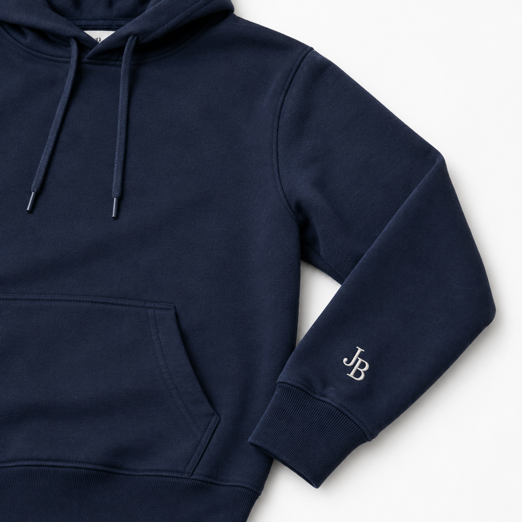 Custom embroidery on the left sleeve of a dark navy hoodie